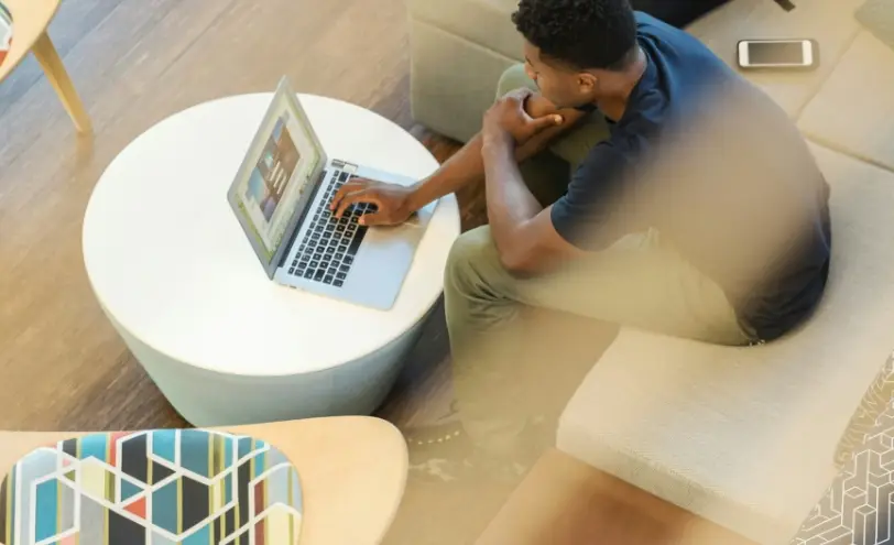 Resident working on a laptop at Urbania NoMi 125, North Miami apartments