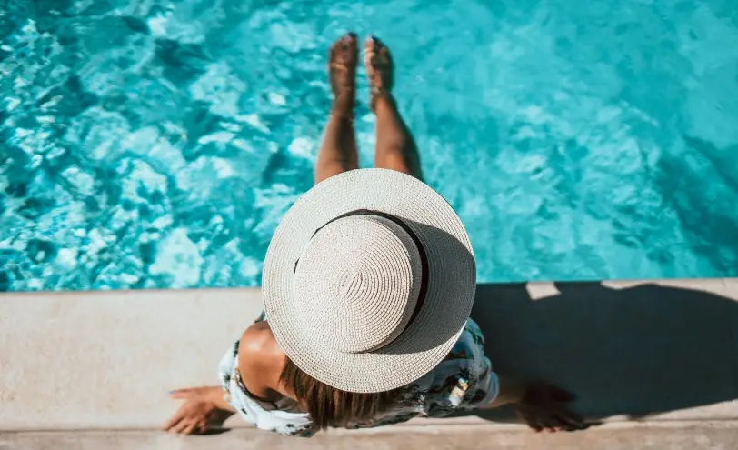 Resident relaxing poolside at Urbania NoMi 125, new apartments in North Miami, FL
